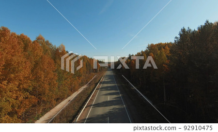 FPV drone high-speed flight along the road and autumn forest in Ural FPV drone high-speed flight along the road and autumn forest in Ural 92910475