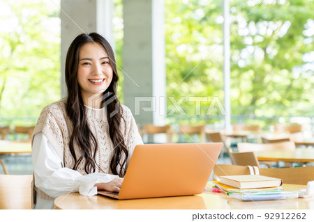 College girl using a computer on campus 92912262