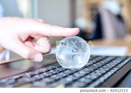 Image cut of a young woman who works and a crystal globe Image cut of a young woman who works and a crystal globe 92912513
