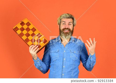 Hobby and leisure. Intellectual games. Intelligent bearded hipster. Cognitive skills. Chess lesson. Teacher chess competition. Chess figures. Game strategy concept. Board game. Man playing chess 92913384