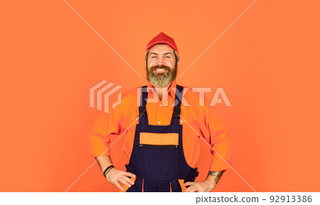 man wear boilersuit. bearded worker in overalls. Confident Mature Mechanic. Portrait Of Repairman. Worker in storehouse. Caucasian workman in storeroom. Mad repairman concept man wear boilersuit. bearded worker in overalls. Confident Mature Mechanic. Portrait Of Repairman. Worker in storehouse. Caucasian workman in storeroom. Mad repairman concept 92913386