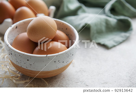 Bowl of eggs on concrete background 92913642