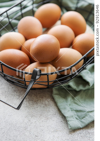 Basket of fresh brown eggs 92913646