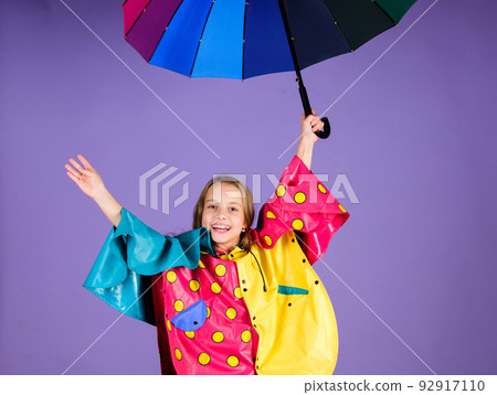 Enjoy rainy weather with proper garments. Waterproof accessories for children. Waterproof accessories make rainy day cheerful and pleasant. Kid girl happy hold colorful umbrella wear waterproof cloak Enjoy rainy weather with proper garments. Waterproof accessories for children. Waterproof accessories make rainy day cheerful and pleasant. Kid girl happy hold colorful umbrella wear waterproof cloak 92917110