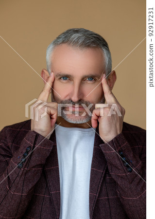 Mid aged good-looking man touching his head Mid aged good-looking man touching his head 92917231