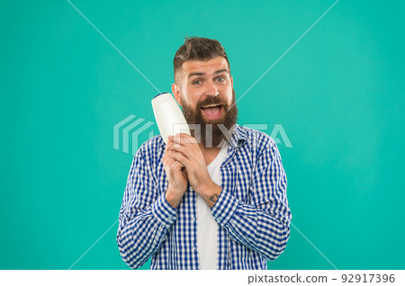 Barbershop and hair care. Shampoo review concept. Test beauty product. Launching beauty product. Hair conditioner or lotion. Man bearded hipster hold bottle shampoo or shower gel. Hair care treatment 92917396