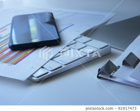 Business image of graphs, documents, personal computers, smartphones 92917473