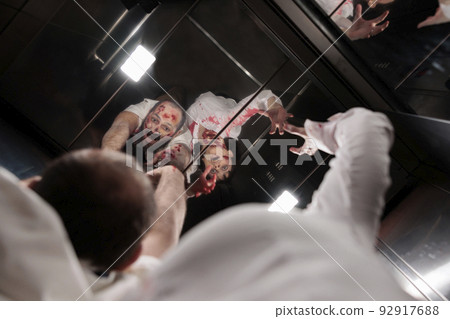 Walking dead evil corpses in elevator having bloody wounds and hunting people in company office. Brain eating devil zombie monsters chasing victims, creepy terror eerie massacre. 92917688