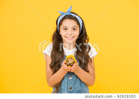 Treat someone with sweets. Yummy cupcake. Homemade muffin. Bakery confectionery concept. Kid girl hold muffin. Gluten free recipe. Delicious cupcake. Little child with muffin on yellow background Treat someone with sweets. Yummy cupcake. Homemade muffin. Bakery confectionery concept. Kid girl hold muffin. Gluten free recipe. Delicious cupcake. Little child with muffin on yellow background 92918103
