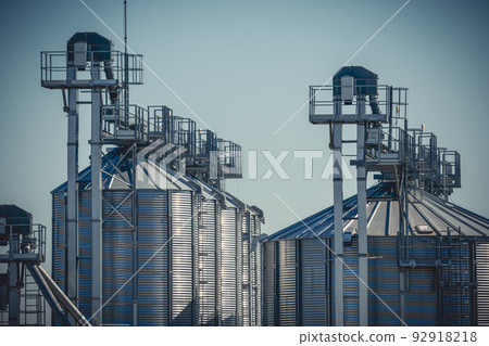 Close-up of agro silos granary elevator on agro-processing manufacturing plant 92918218