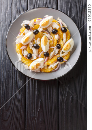 remojon granadino, salt cod orange and olive salad, spanish cuisine close-up in a plate. Vertical top view 92918350
