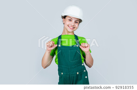 Foreman inspector. future engineer. happy kid wearing uniform for repairing. building construction site. child architect worker. labor day concept. childhood development. teenager girl assistant Foreman inspector. future engineer. happy kid wearing uniform for repairing. building construction site. child architect worker. labor day concept. childhood development. teenager girl assistant 92918355