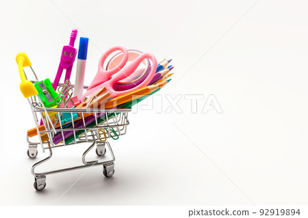 Shopping trolley filled with multicolored school supplies i 92919894