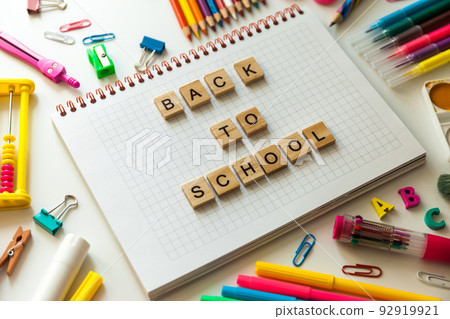 School office supplies and opened notebook on a desk 92919921