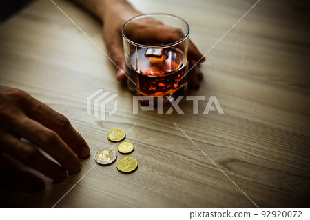 Fired man countsing his last money to drink expensive alcohol. Fired man countsing his last money to drink expensive alcohol. 92920072