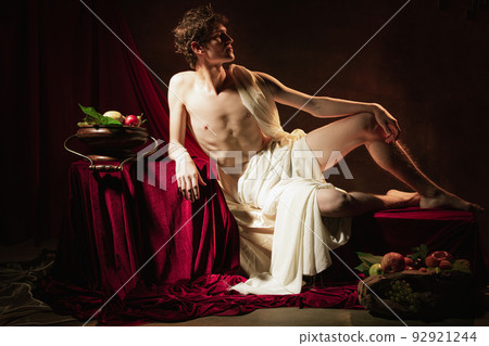 Colorful fictional portrait of young adorable man in image of famous historical character, medieval person isolated on dark vintage background. Retro style 92921244