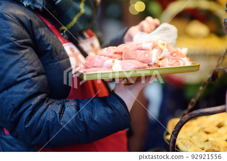 Traditional Poland street food oscypek is a grilled cheese of salted sheep milk with different ingredients as bacon or jams. Cooking of oscypek on Christmas market in Krakow. Traditional Poland street food oscypek is a grilled cheese of salted sheep milk with different ingredients as bacon or jams. Cooking of oscypek on Christmas market in Krakow. 92921556