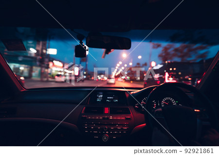 Driver drive a car on night city with cyber punk neon traffic light. Driver drive a car on night city with cyber punk neon traffic light. 92921861