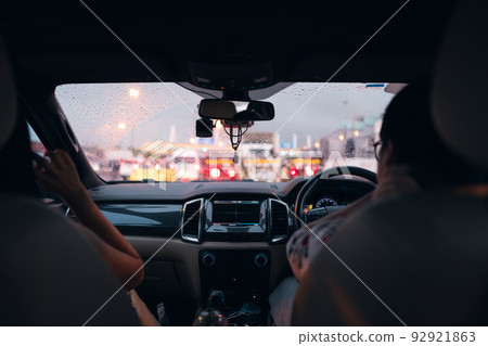 Adult asian traveller couple get traffic jam on highway when heavy rain road slip Adult asian traveller couple get traffic jam on highway when heavy rain road slip 92921863