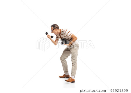 Portrait of stylish businessman in retro clothes shouting on vintage phone isolated over white background. Expressing anger Portrait of stylish businessman in retro clothes shouting on vintage phone isolated over white background. Expressing anger 92921899
