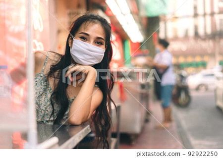 Happy asian adult woman wear protect mask for new normal life. 92922250