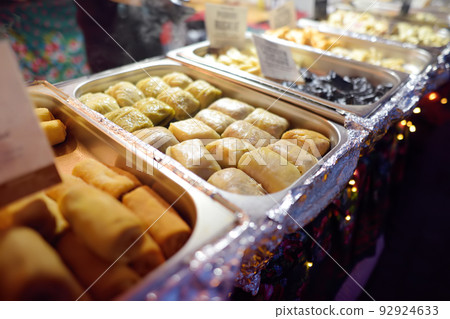 Hot food on Krakow Christmas market. Gabbage rolls, pancakes and other semi-finished products . Traditional european cuisine. 92924633
