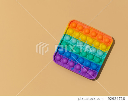 Popit toy on pastel beige background, top view Popit toy on pastel beige background, top view 92924718