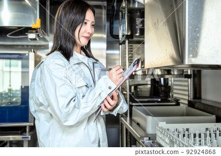 Young woman checking the kitchen Young woman checking the kitchen 92924868