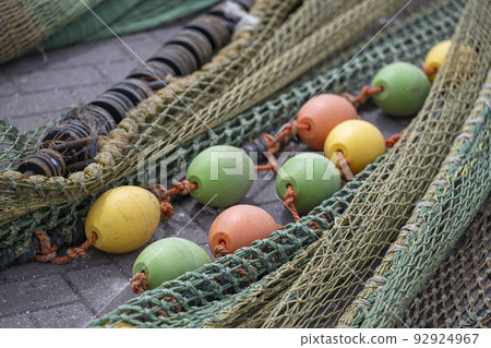 Colored nets and ropes on a quay. Colored nets and ropes on a quay. 92924967