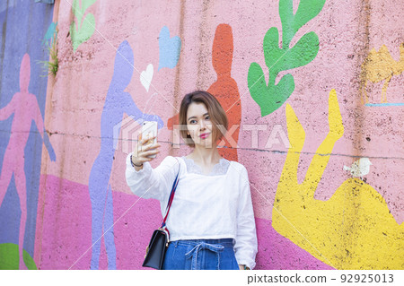 Woman taking a selfie 92925013