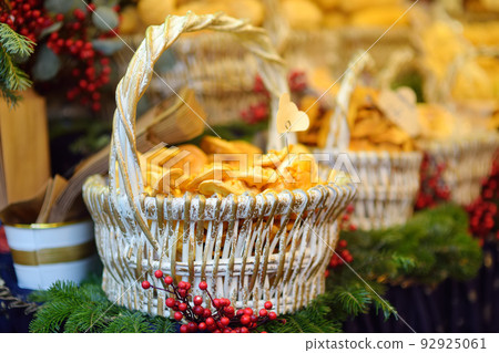 Traditional Poland street food oscypek is a grilled cheese of salted sheep milk with different ingredients as bacon or jams. Basket of oscypek on Christmas market in Krakow. 92925061