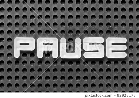 White alphabet letter in word pause on black pegboard background 92925175
