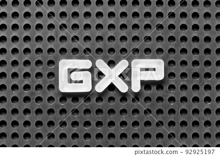 White alphabet letter in word GXP on black pegboard background 92925197