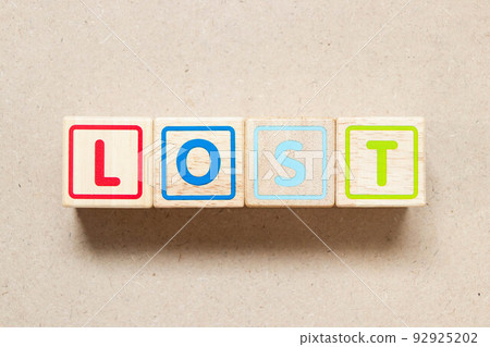Color letter block in word lost on wood background 92925202