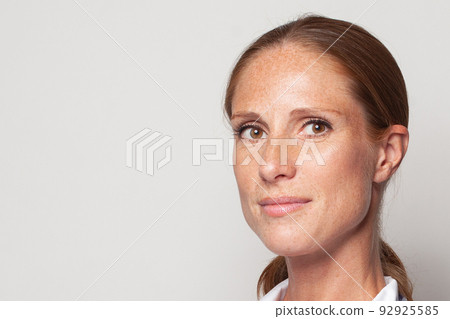 Natural beauty. Portrait of middle-aged woman with freckles closeup Natural beauty. Portrait of middle-aged woman with freckles closeup 92925585
