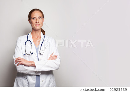 Female medical nurse or practitioner with stethoscope looking at camera. Healthcare concept Female medical nurse or practitioner with stethoscope looking at camera. Healthcare concept 92925589