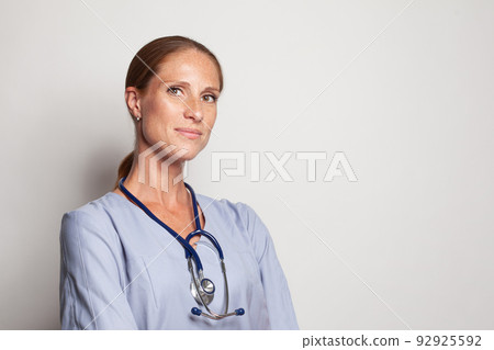 Friendly positive doctor woman looking at camera, closeup portrait Friendly positive doctor woman looking at camera, closeup portrait 92925592