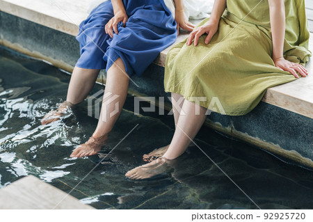 A woman immersed in a foot bath 92925720