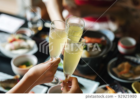 A woman toasting at an inn 92925980