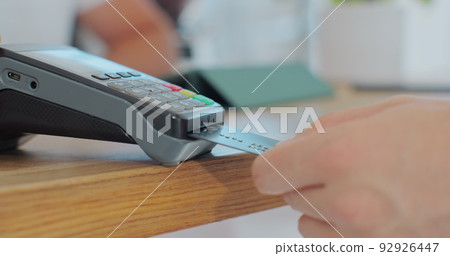 Credit card machine for money transaction. Man hand with credit card swipe through pos terminal and enter pin code. Banking services of electronic money. Financial success and safety. Credit card machine for money transaction. Man hand with credit card swipe through pos terminal and enter pin code. Banking services of electronic money. Financial success and safety. 92926447