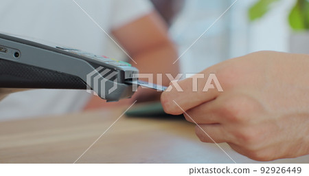 Credit card machine for money transaction. Man hand with credit card swipe through pos terminal and enter pin code. Banking services of electronic money. Financial success and safety. Credit card machine for money transaction. Man hand with credit card swipe through pos terminal and enter pin code. Banking services of electronic money. Financial success and safety. 92926449