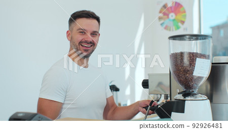 Man barista is making a cappuccino in a coffee shop bar. Coffee shop concept. Man barista is making a cappuccino in a coffee shop bar. Coffee shop concept. 92926481