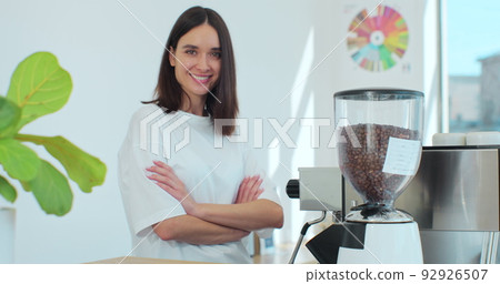 Successful small business owner woman standing with crossed arms. Portrait of young female cafe owner. Coffee shop concept. Successful small business owner woman standing with crossed arms. Portrait of young female cafe owner. Coffee shop concept. 92926507