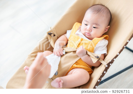 A baby playing with a gauze handkerchief A baby playing with a gauze handkerchief 92926731