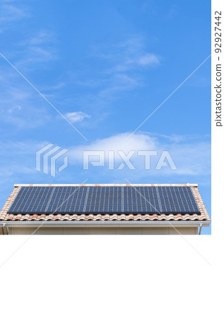 [Environmental image] Residential roofs with solar panels and a clear blue sky with white copy space. 92927442