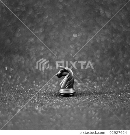 black chess knight horse on the black bokeh background. photo black chess knight horse on the black bokeh background. photo 92927624