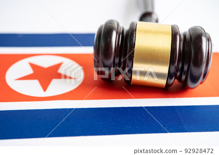 North Korea flag with gavel for judge lawyer. Law and justice court concept. North Korea flag with gavel for judge lawyer. Law and justice court concept. 92928472