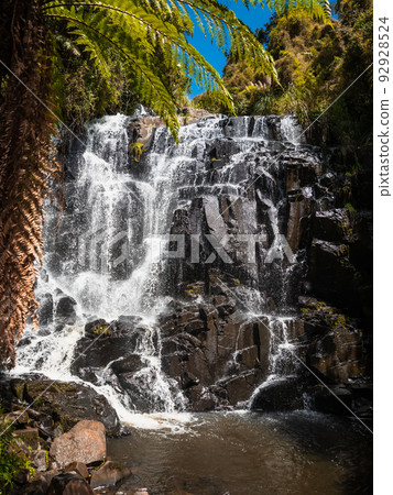 Cascade waterfall with tropical plants in sunny day 92928524