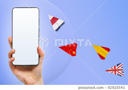 Online education. Female hand holds a smartphone with mock up. Flying paper airplanes with flags of different countries. Concept of learning foreign languages and internet translator Online education. Female hand holds a smartphone with mock up. Flying paper airplanes with flags of different countries. Concept of learning foreign languages and internet translator 92928541