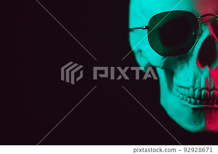 human skull wearing sunglasses with pink green neon light human skull wearing sunglasses with pink green neon light 92928671